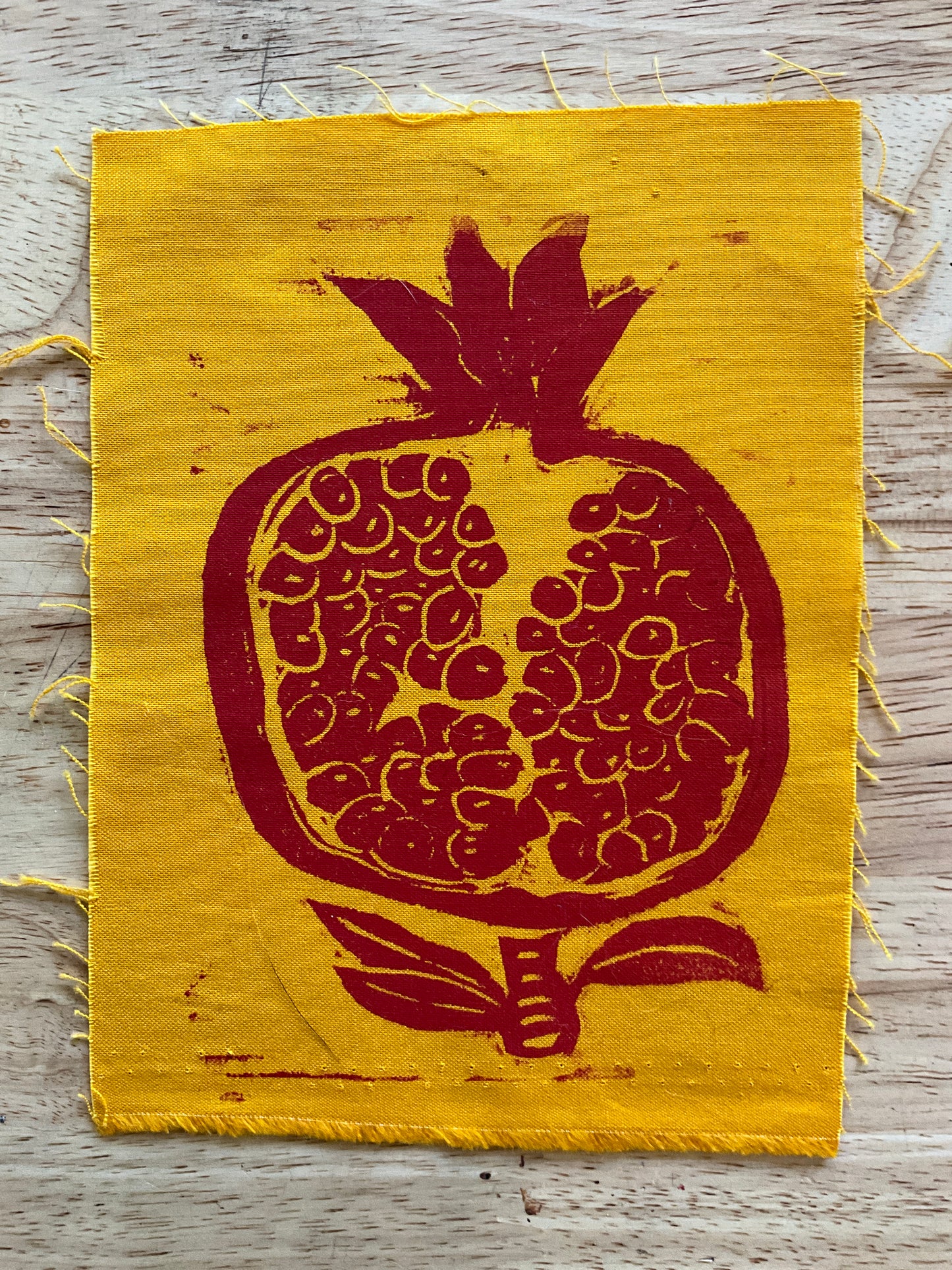 Pomegranate on yellow fabric