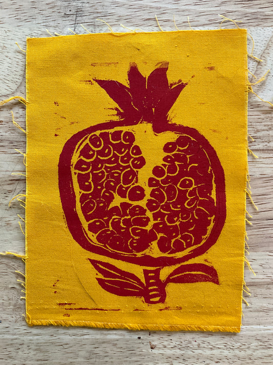 Pomegranate on yellow fabric